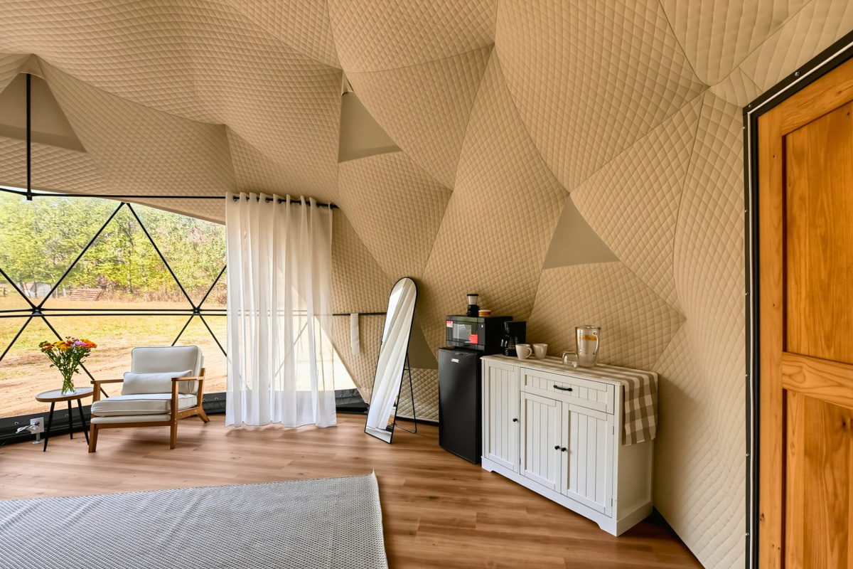 Make yourself comfortable with a cozy seating area, mini fridge, and microwave inside your dome.