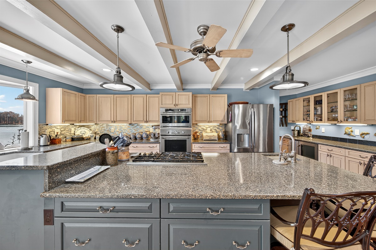 Beautiful custom cabinetry, granite counters, and pendant lighting throughout.