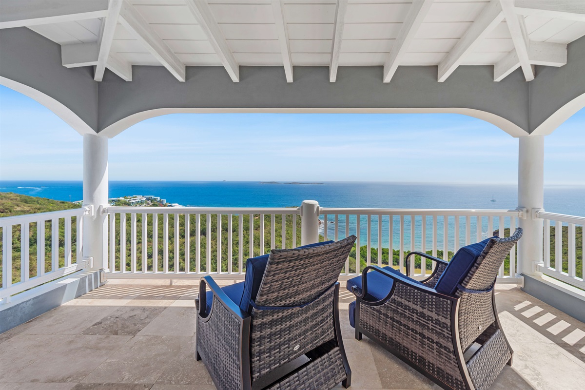 Enjoy quiet moments on the shaded balcony with panoramic sea views.