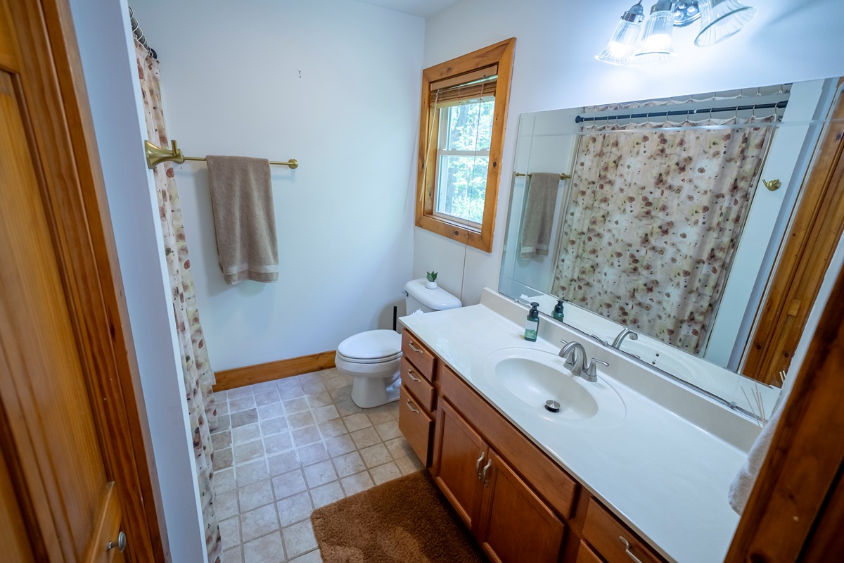 Bright vanity with generous counter space and storage for a comfortable stay.