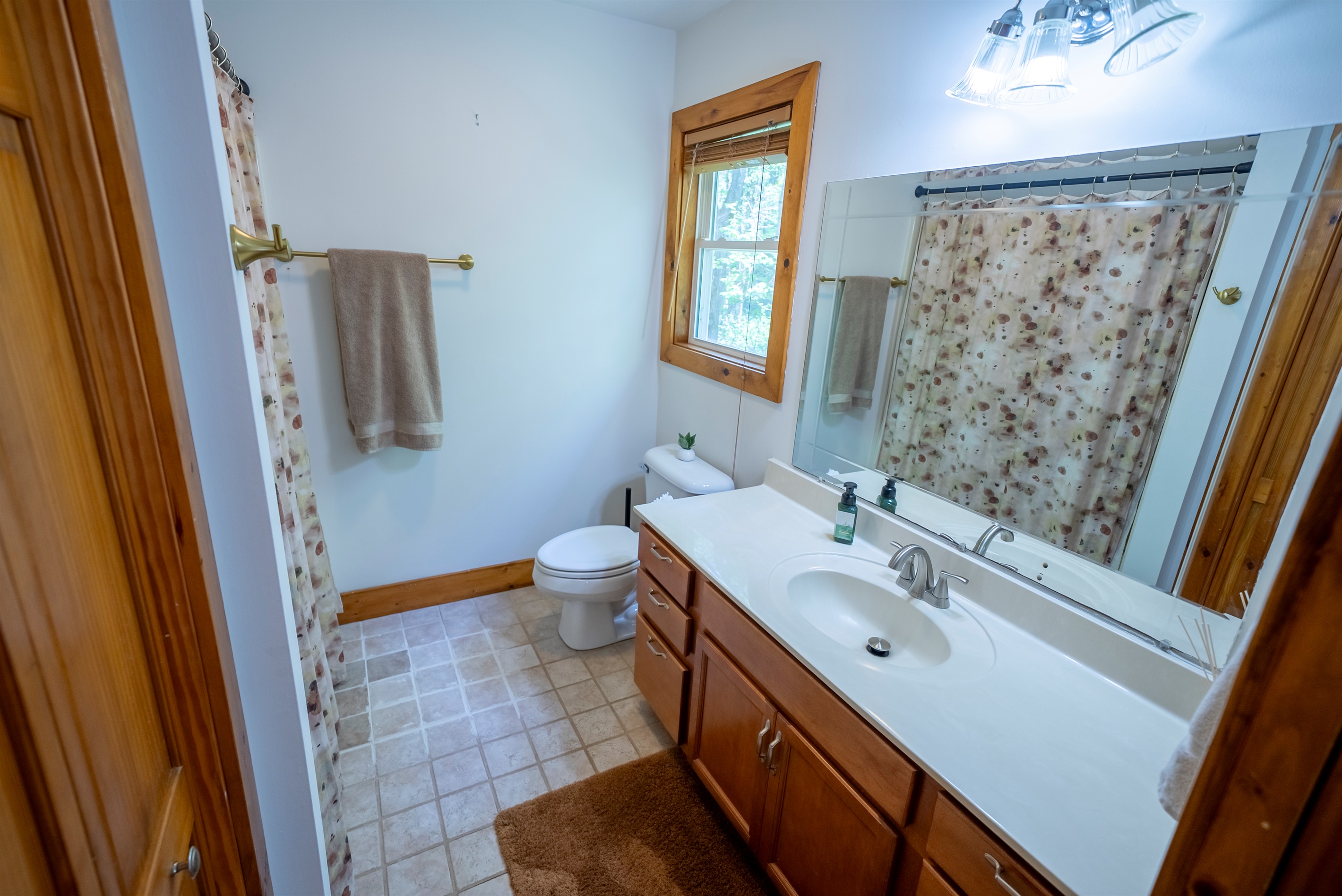 Bright vanity with generous counter space and storage for a comfortable stay.