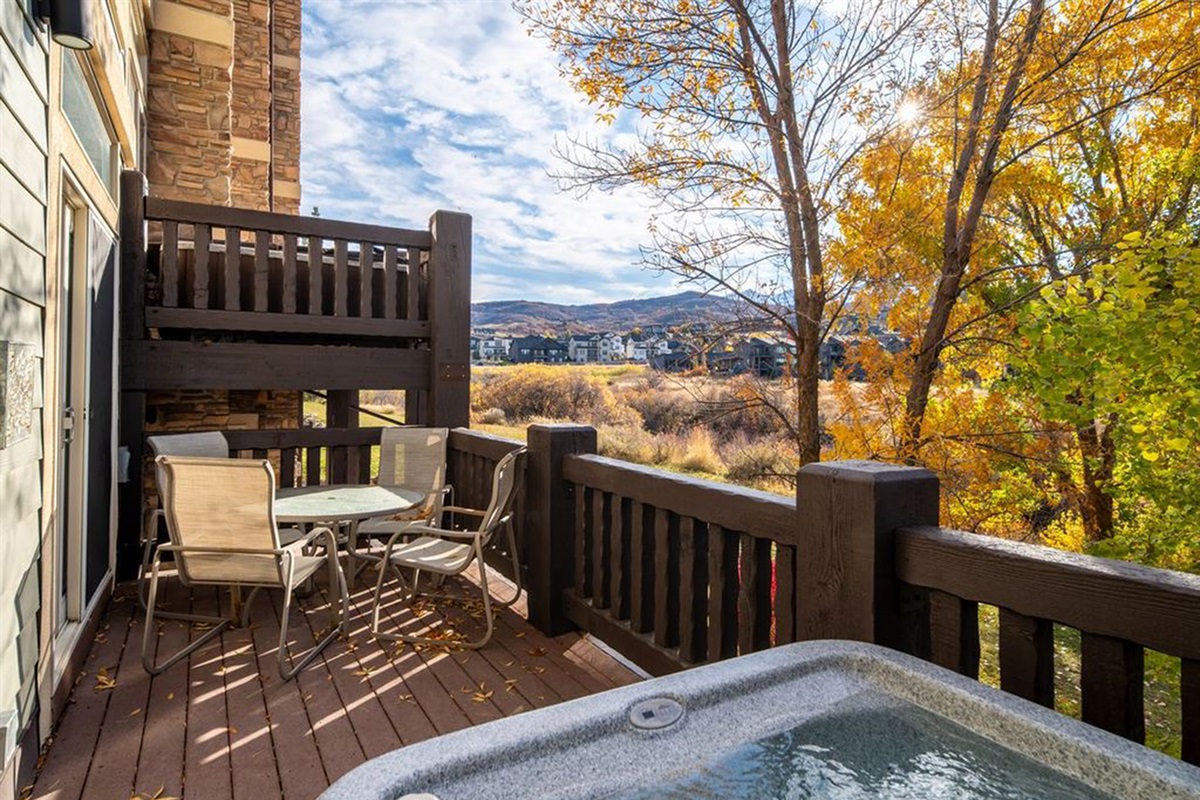 Private deck with hot tub and seating—perfect for relaxing in the fresh mountain air.