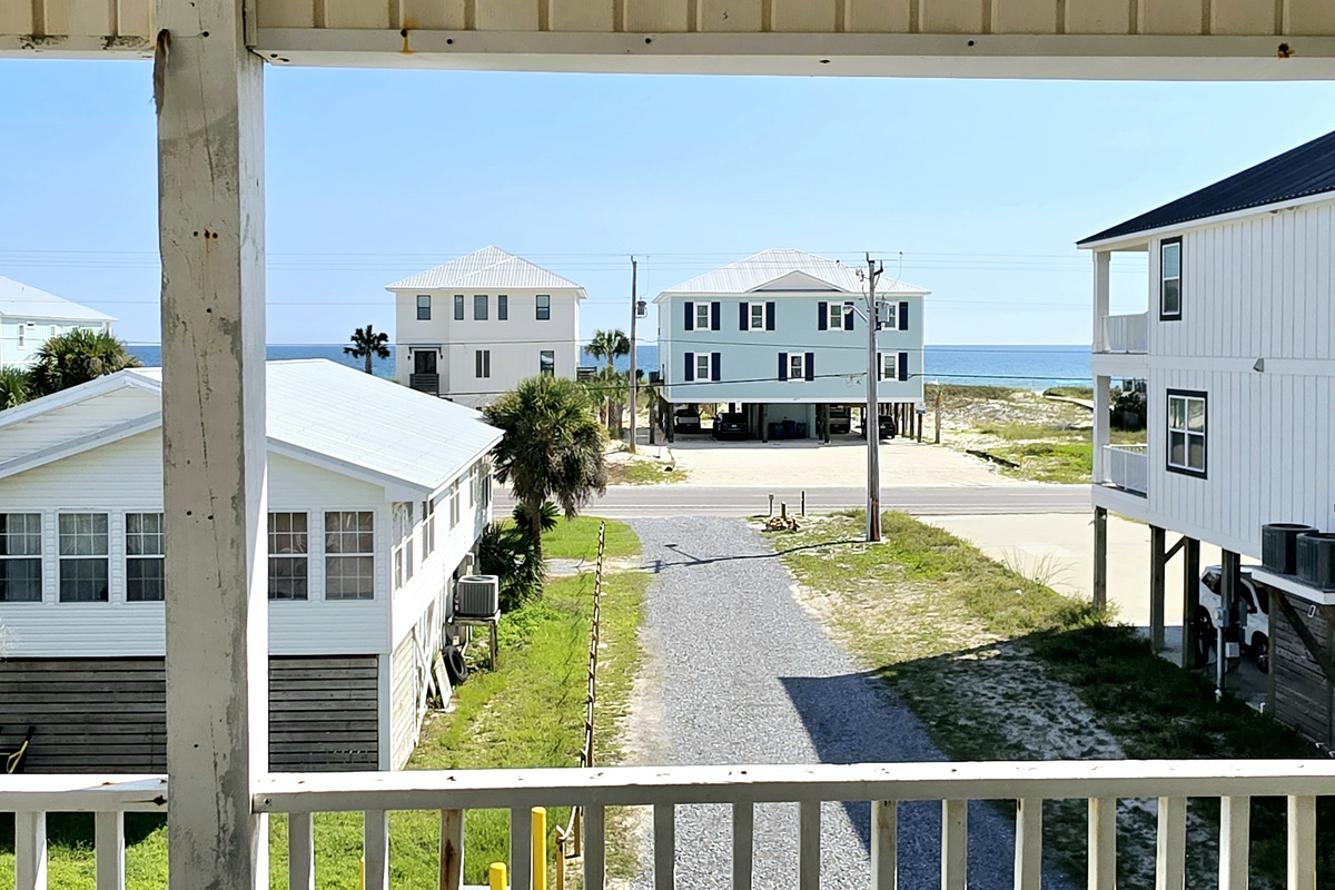 Balcony view down the street with the water in the distance