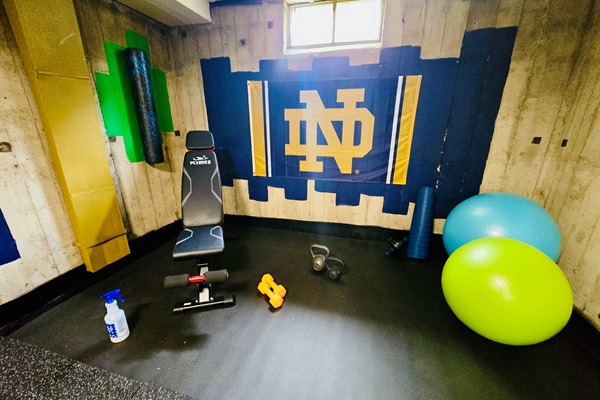 Fuel Your Focus, Channel the Irish Bold ND pride and vibrant gear set the tone—this basement gym is built to ignite your drive, elevate your mindset, and keep you moving toward your goals.