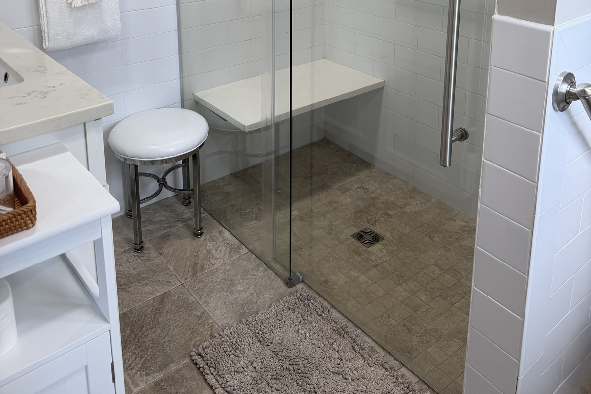 Frame-less glass shower with bench and grab rails