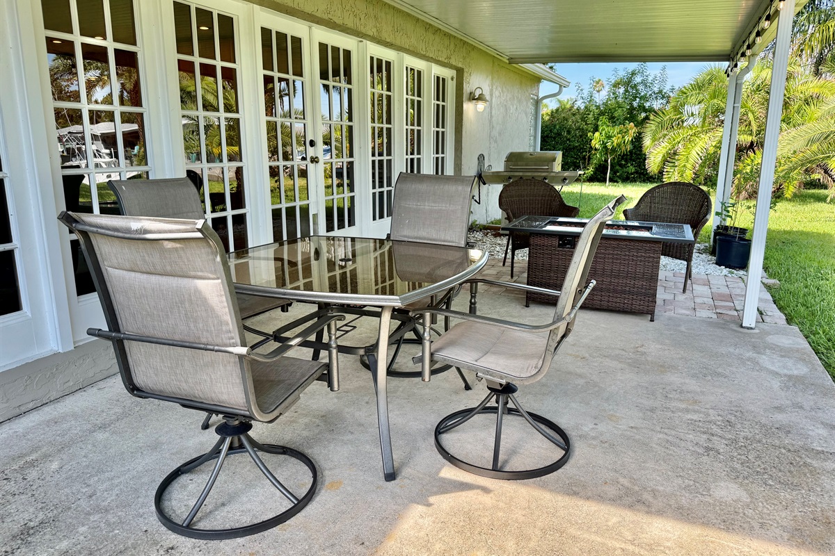 Gather around the outdoor dining table for a fresh-air meal, then move to the cushioned seating area to enjoy drinks and good conversation by the fire table.