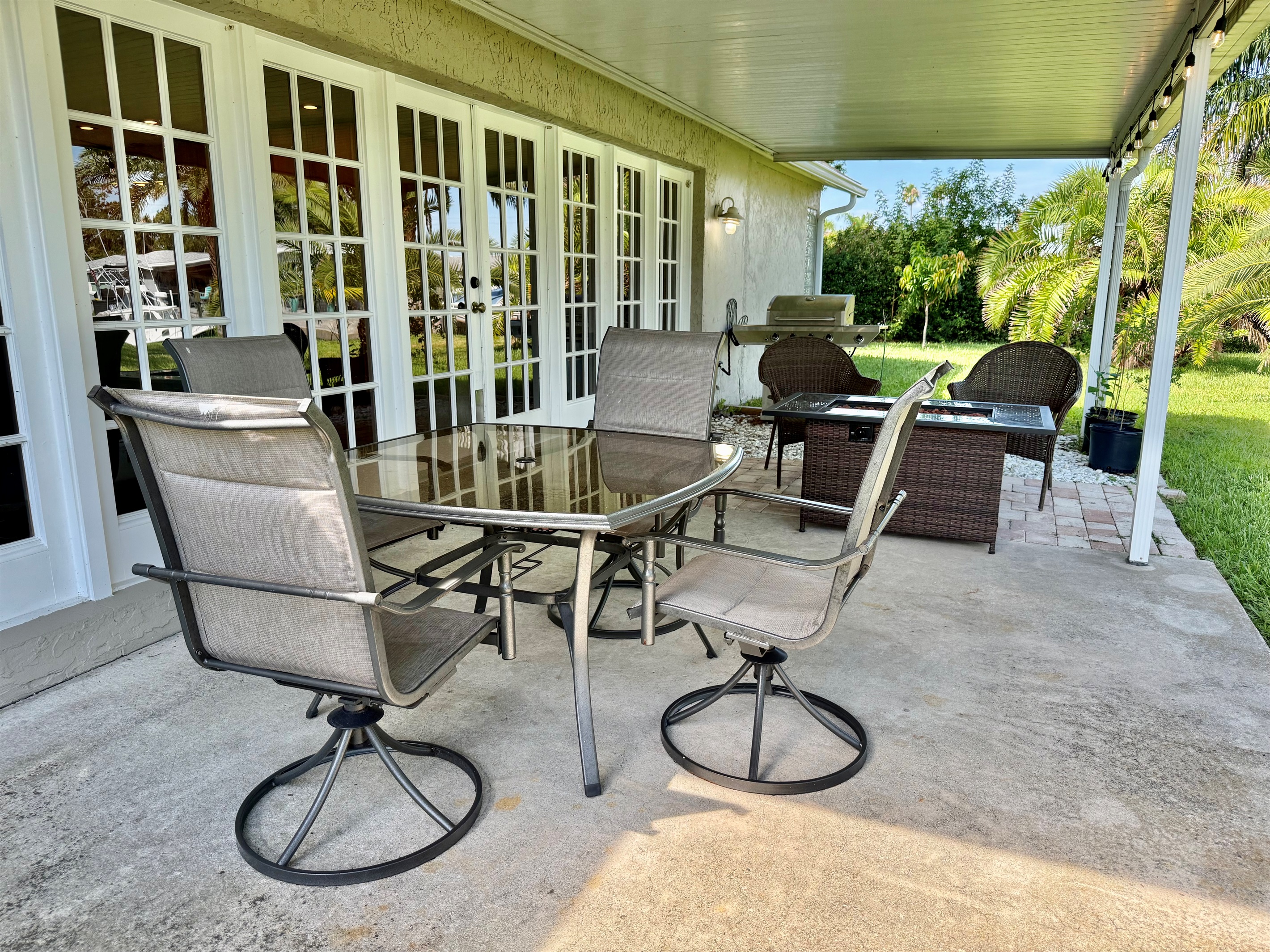 Gather around the outdoor dining table for a fresh-air meal, then move to the cushioned seating area to enjoy drinks and good conversation by the fire table.