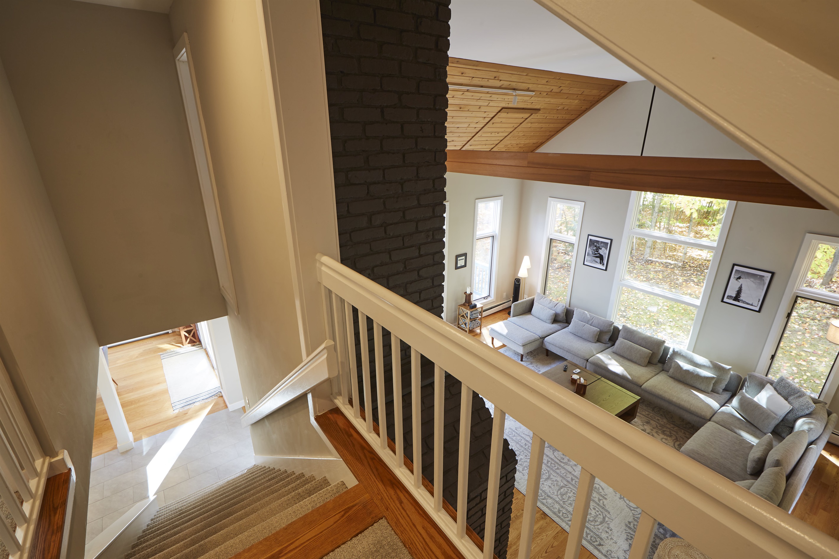 View of the large living room and staircase to the second floor.