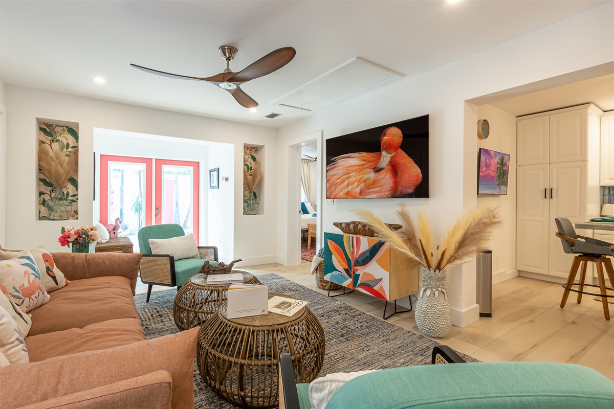 Living Room Oasis: Bright and inviting space with island-inspired decor and stunning art!