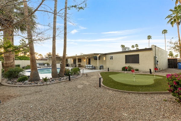 Spacious backyard with putting green and multiple areas to relax and unwind