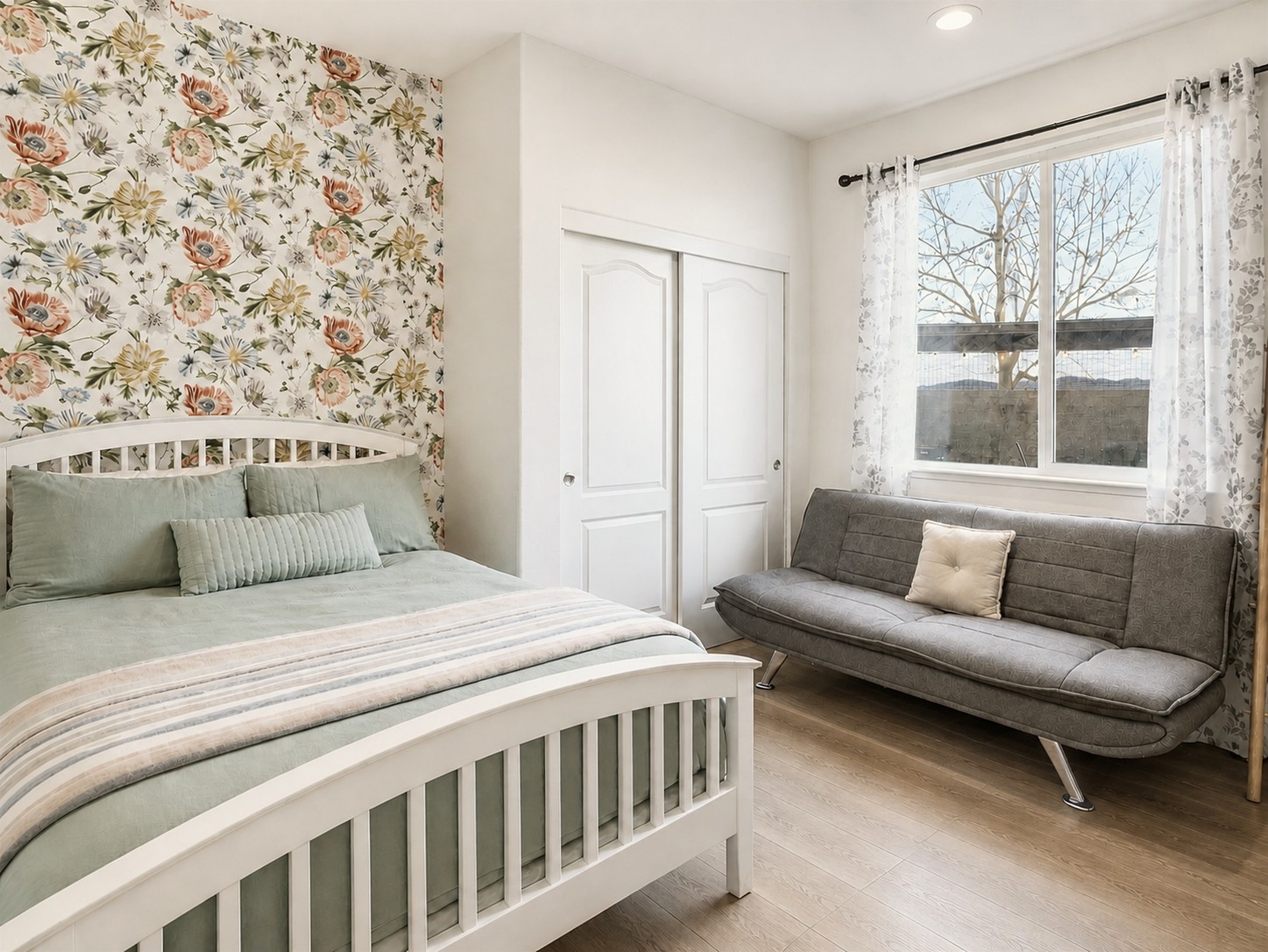 Cozy bedroom with floral accent wall on 1st floor