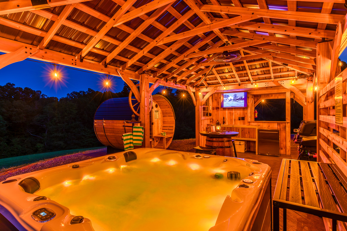 Soak under the pavilion lights with the sauna, outdoor kitchen, and TV just steps away.