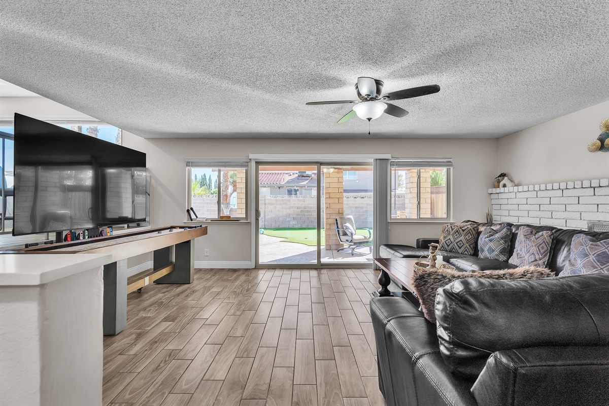 Living room 2 with 86 inch tv, shuffleboard, Nintendo switch, karaoke and bar sink