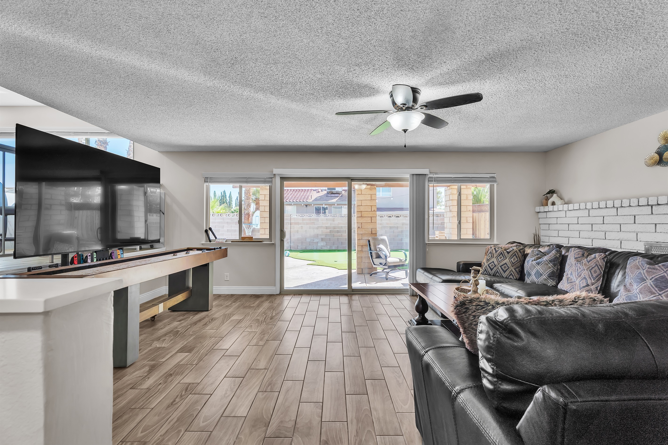 Living room 2 with 86 inch tv, shuffleboard, Nintendo switch, karaoke and bar sink