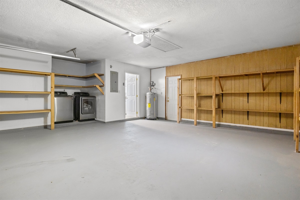 Laundry washer and dryer are located within the garage.