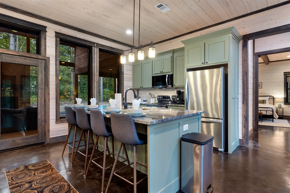 Spacious kitchen island with seating for four, perfect for casual meals, morning coffee, or gathering while cooking together.