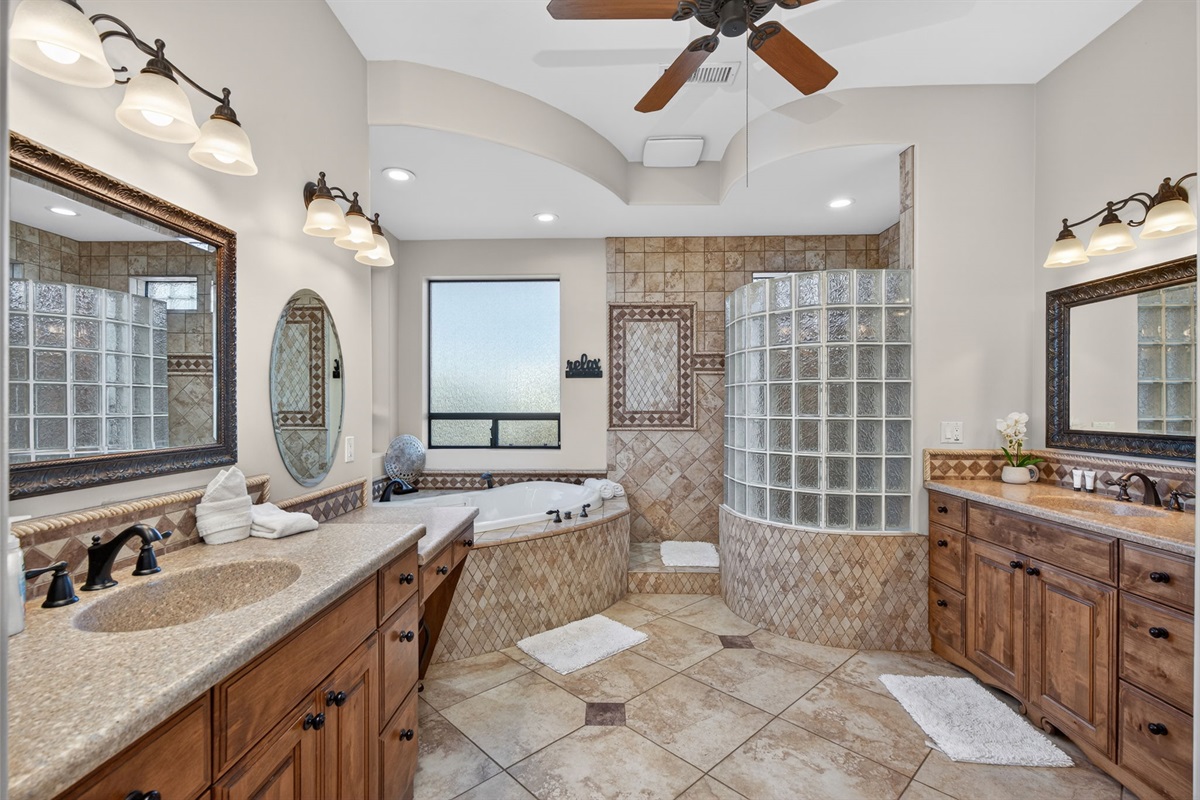 Expansive primary bath layout with double sinks and soaking tub adds comfort and convenience for longer stays
