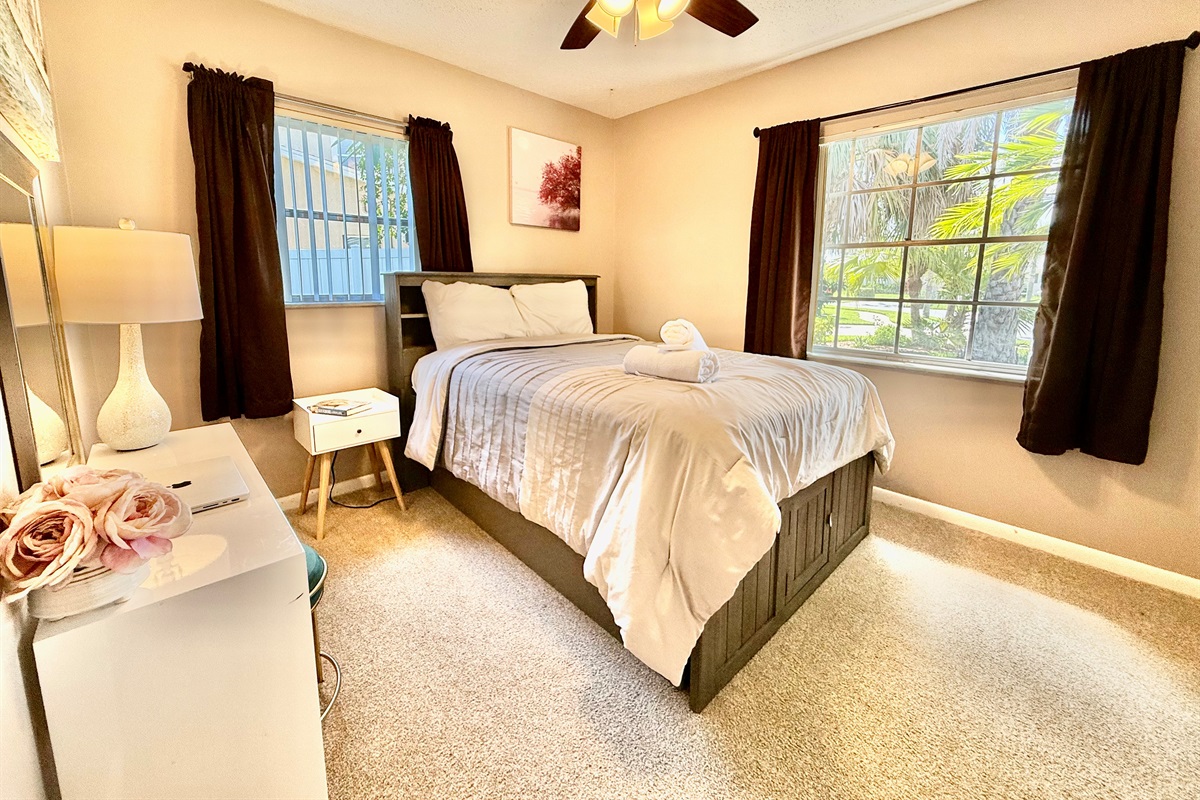 Soft carpet underfoot, warm lighting above, and a comfy bed in between—this space offers the perfect balance of comfort and simplicity.