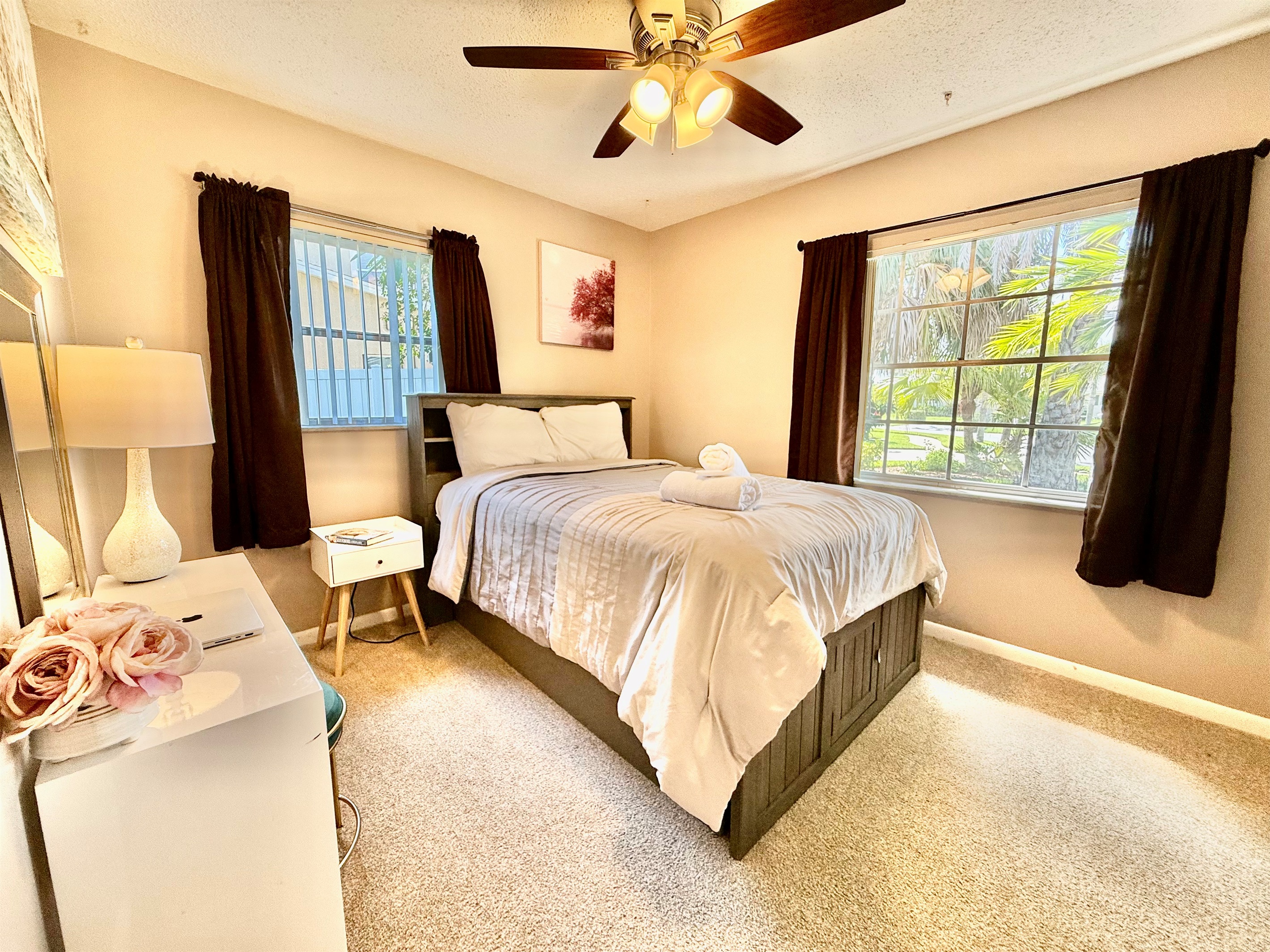 Soft carpet underfoot, warm lighting above, and a comfy bed in between—this space offers the perfect balance of comfort and simplicity.