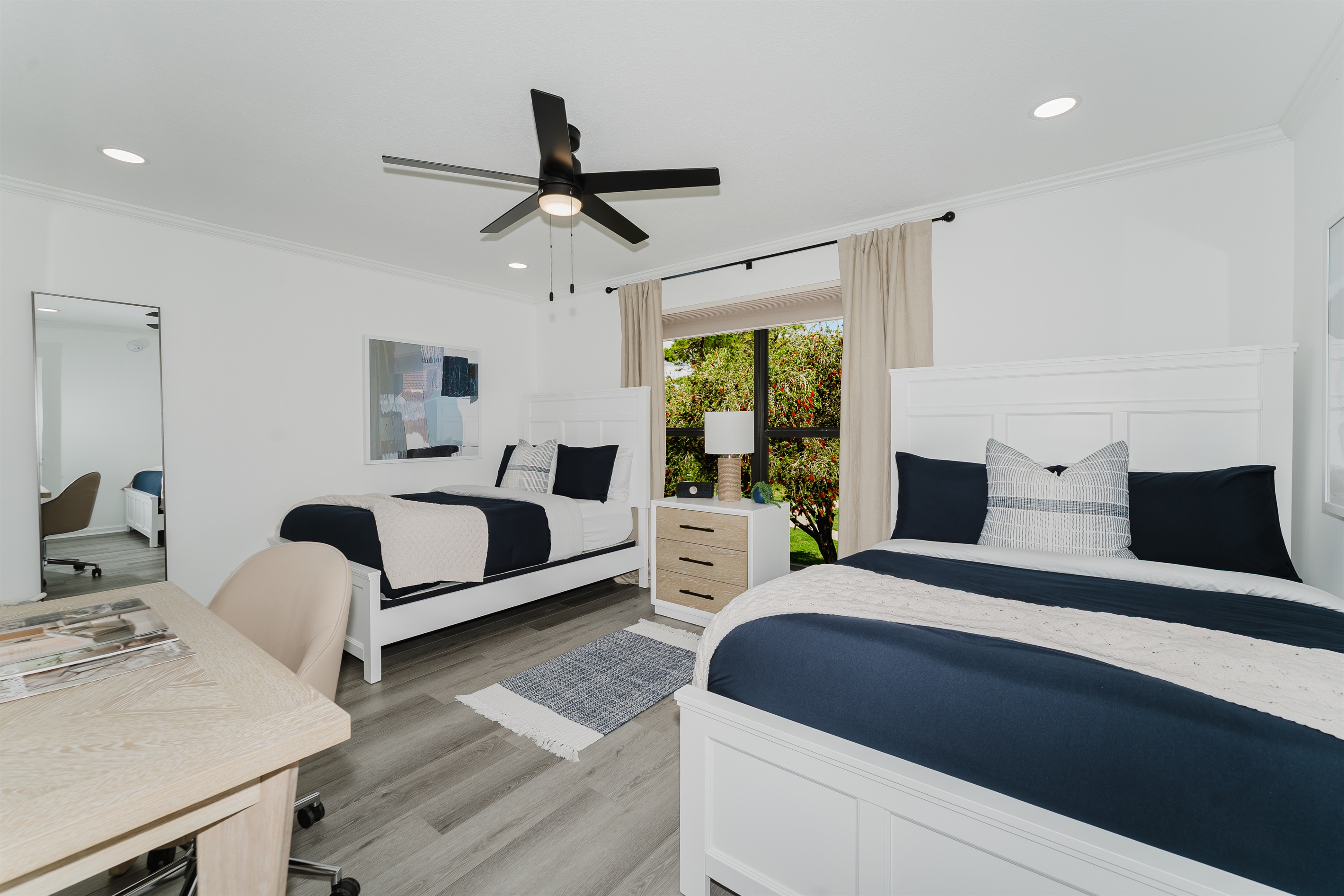 Cozy guest double queen bedroom with comfortable bedding and ample storage. Perfect space for family or friends to unwind and relax. Bright and inviting guest room with stylish touches.