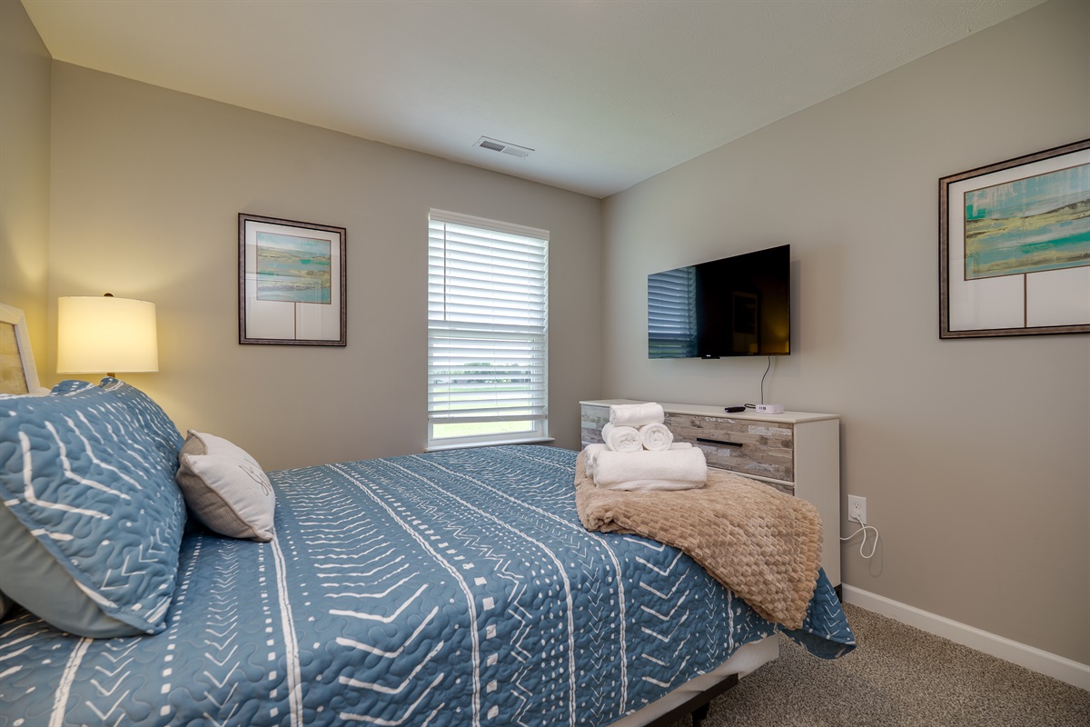 Relax in This Queen-Sized Bedroom with TV