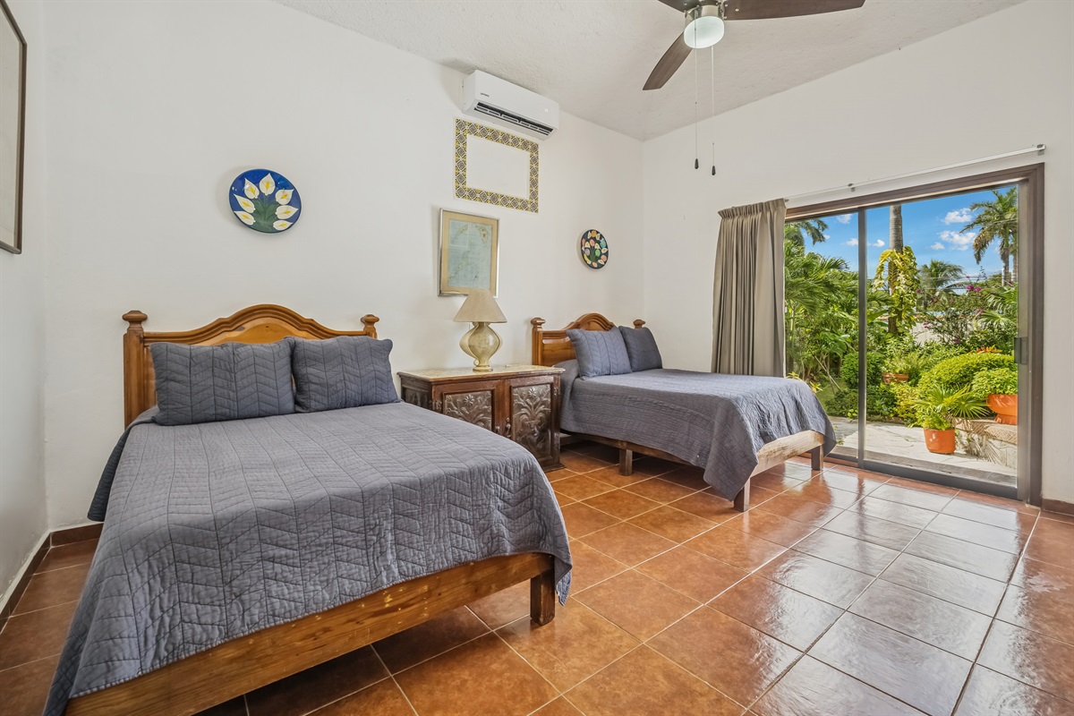 Bedroom 2 on Main Floor with Shared Bathroom and Access to Backyard