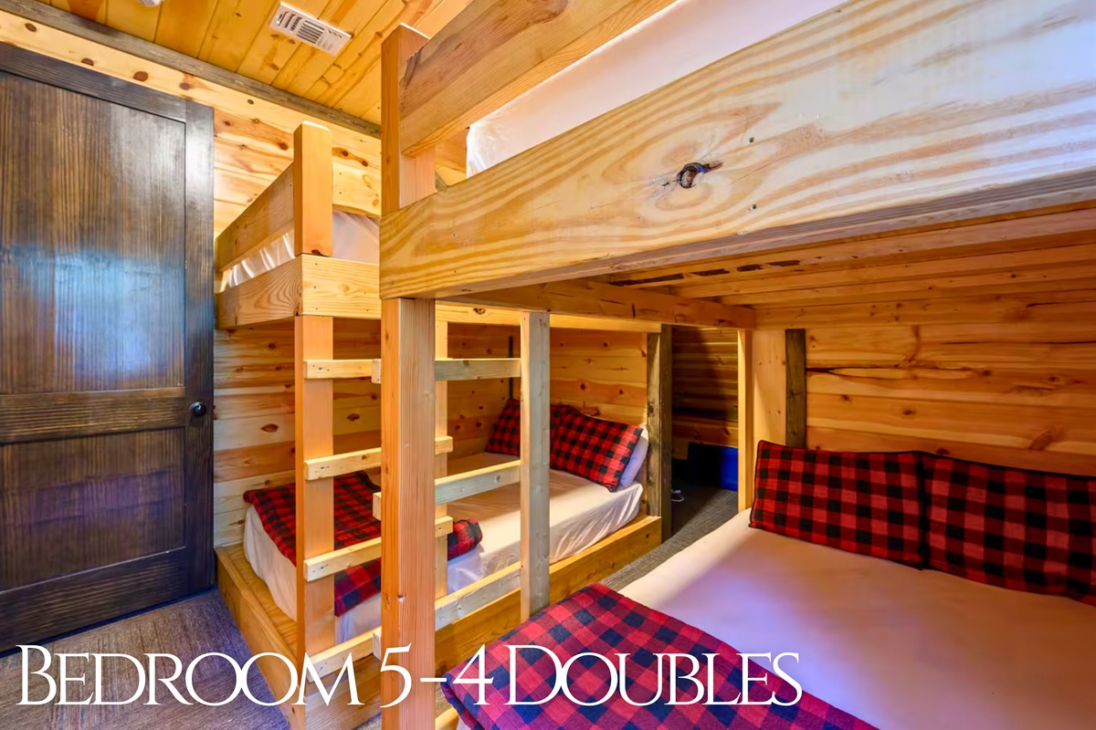 The bunkroom brings the fun with four double beds, cozy plaid bedding, and plenty of space for group adventures.