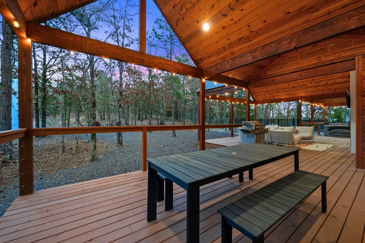 A picnic table on the deck creates a casual spot for meals, morning coffee, or late-night conversations surrounded by nature.