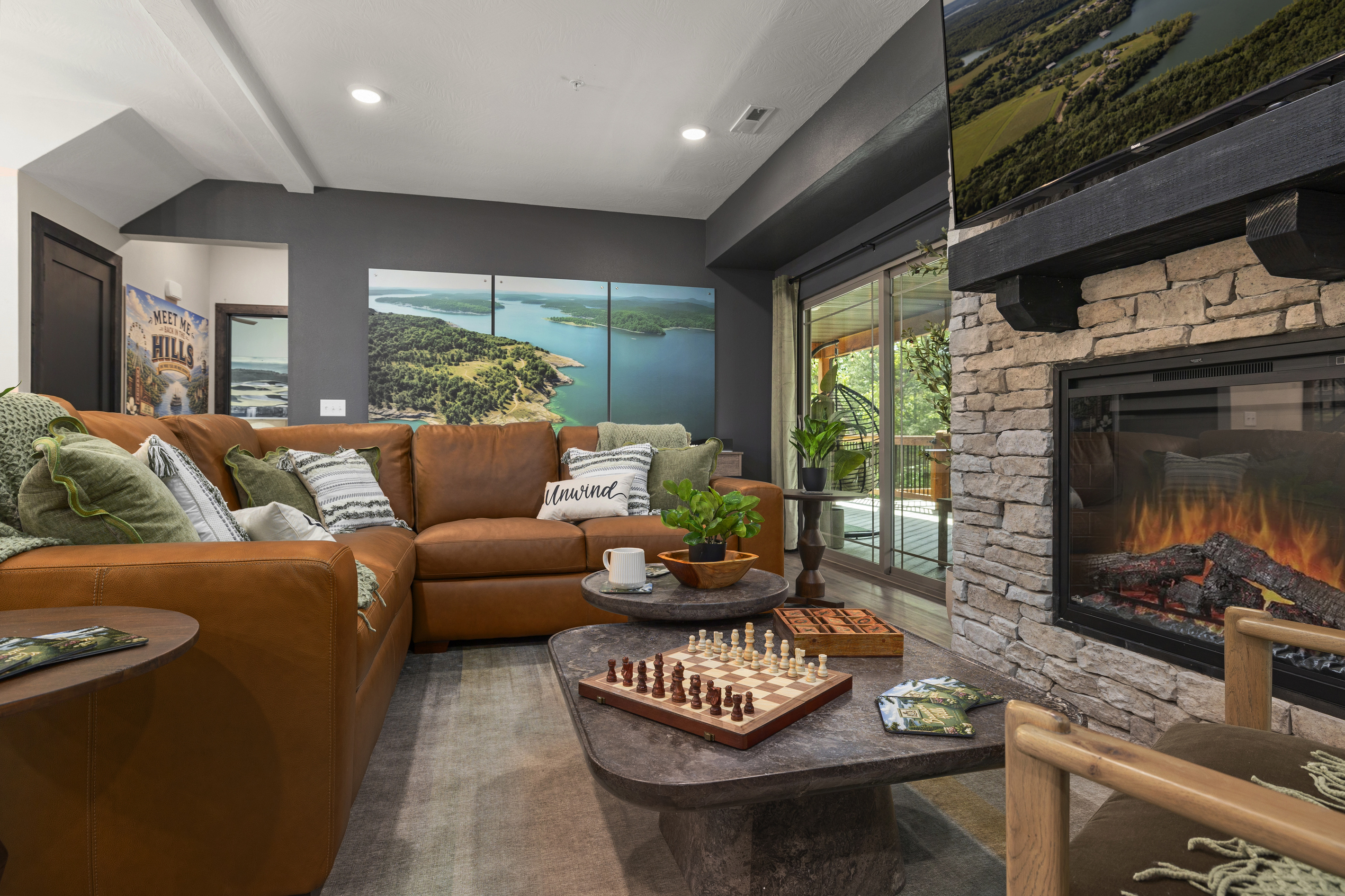 Sink into the leather sectional under the Table Rock Lake mural above the mantel.