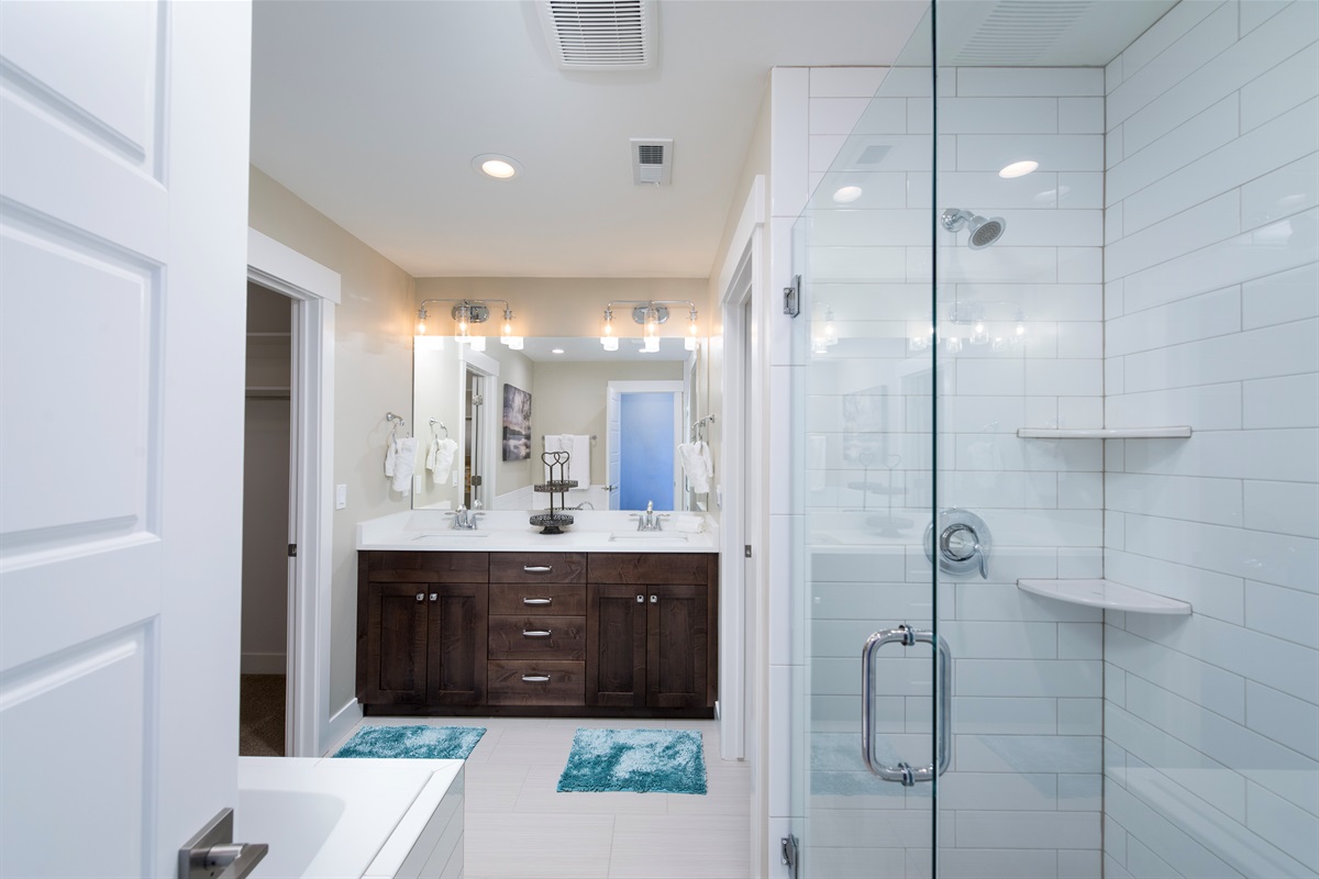 Spa-inspired primary bathroom with dual vanities and luxe finishes