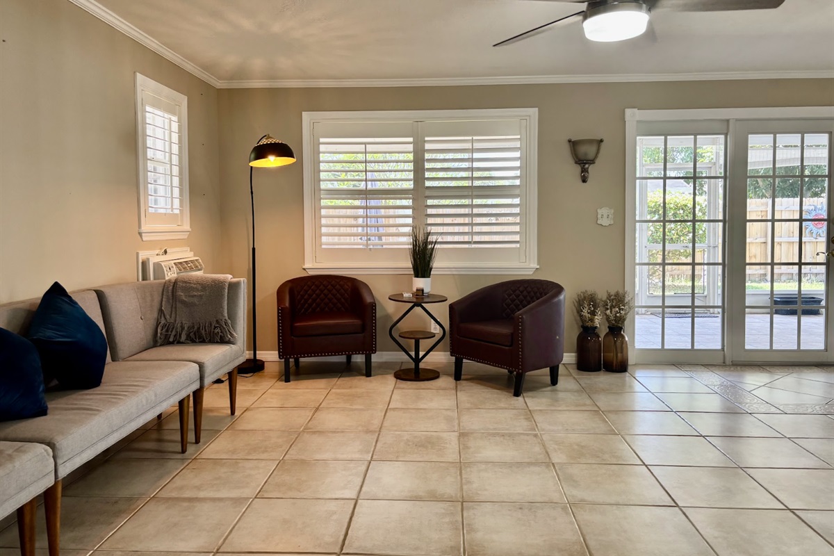 Our expansive rear living room has an abundance of seating and cozy nooks, as well as a comfortable couch with recliners.