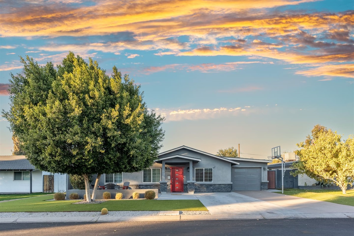 Charming front view of the house from the street, showcasing its architectural features and inviting exterior.