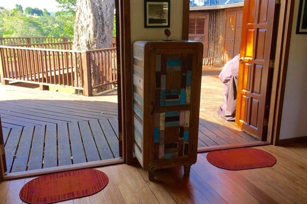 Entrance to the 1st floor full length deck with jungle views. The tree that runs through the Treehouse is the bullet tree that only grows in Belize. 