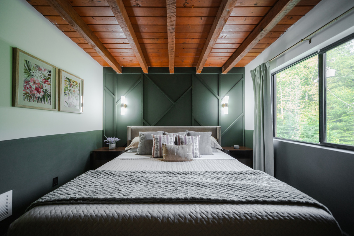 Inviting king bedroom blending cozy cabin character with elevated comfort for a restful retreat.