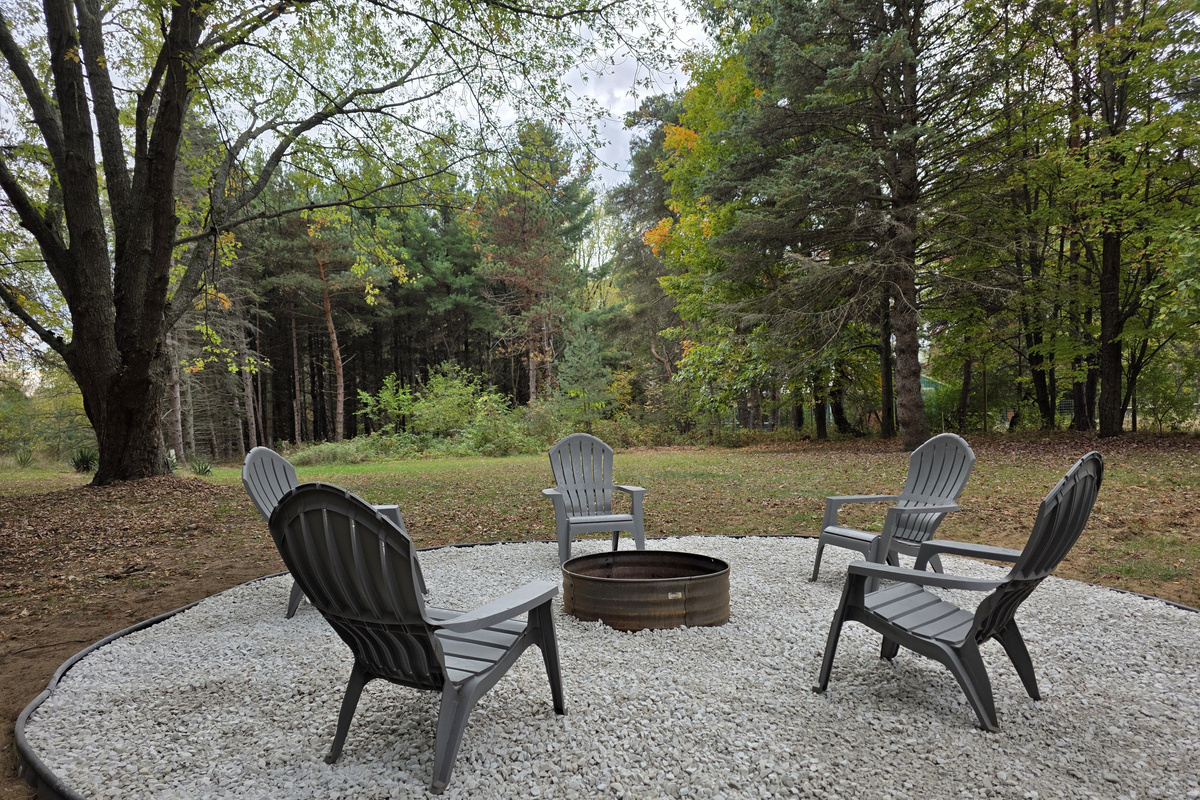 Backyard firepit with Adirondack chairs