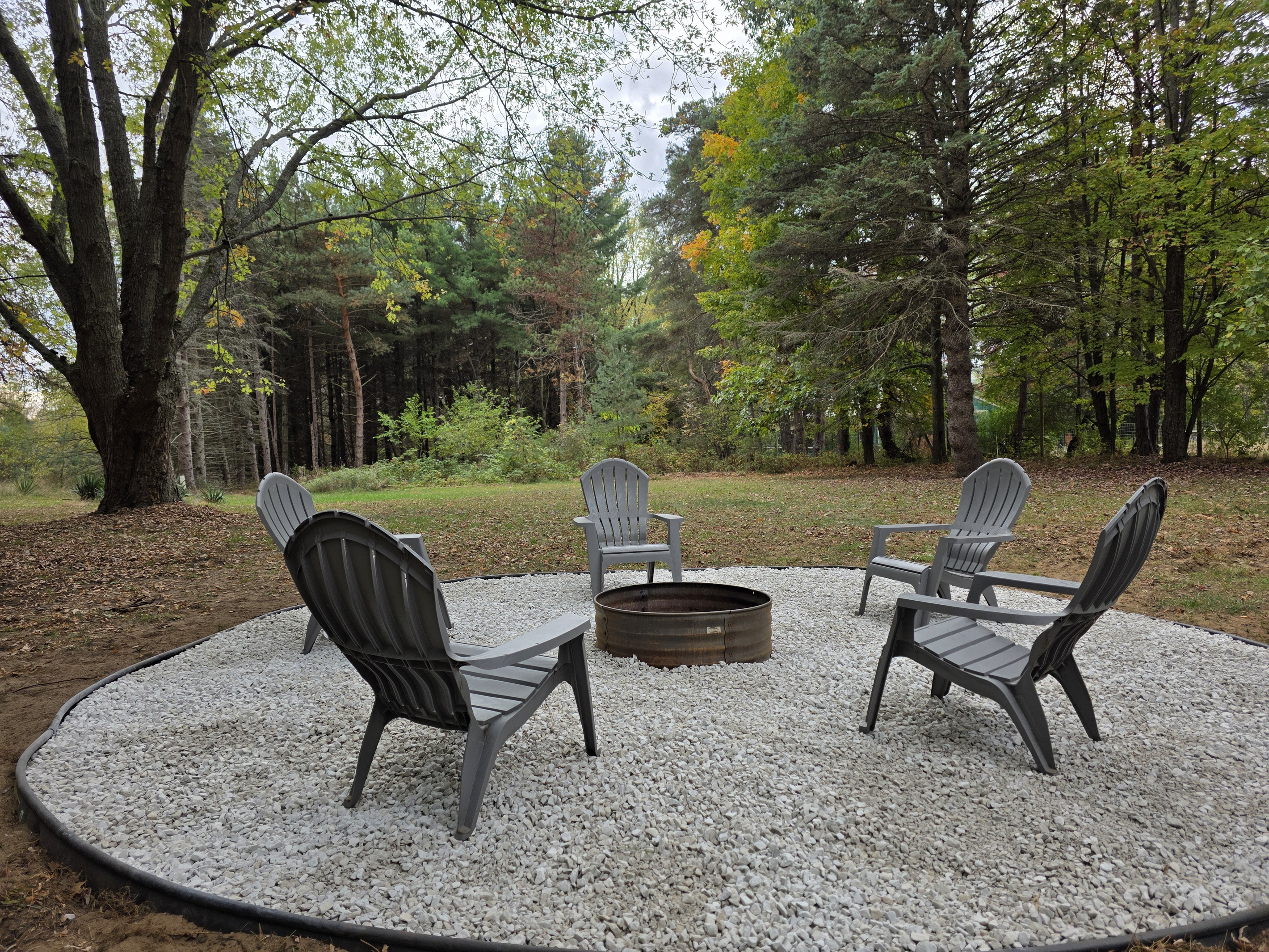 Backyard firepit with Adirondack chairs