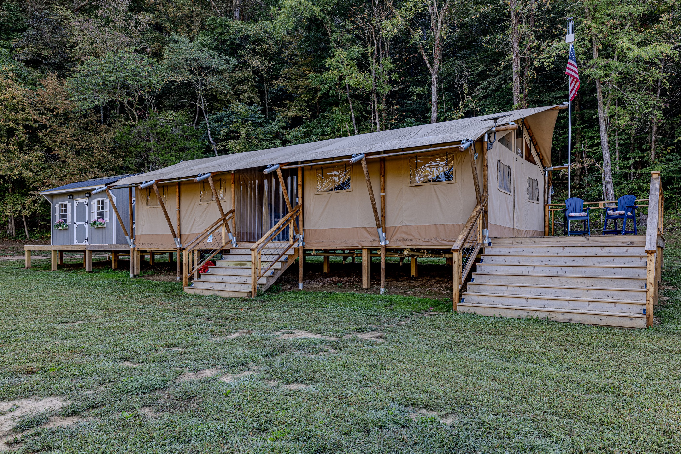 A perfect blend of rustic and refined. Notice the attention to detail—the sturdy steps, the cozy deck seating, and the overall quality that makes your glamping experience truly exceptional.