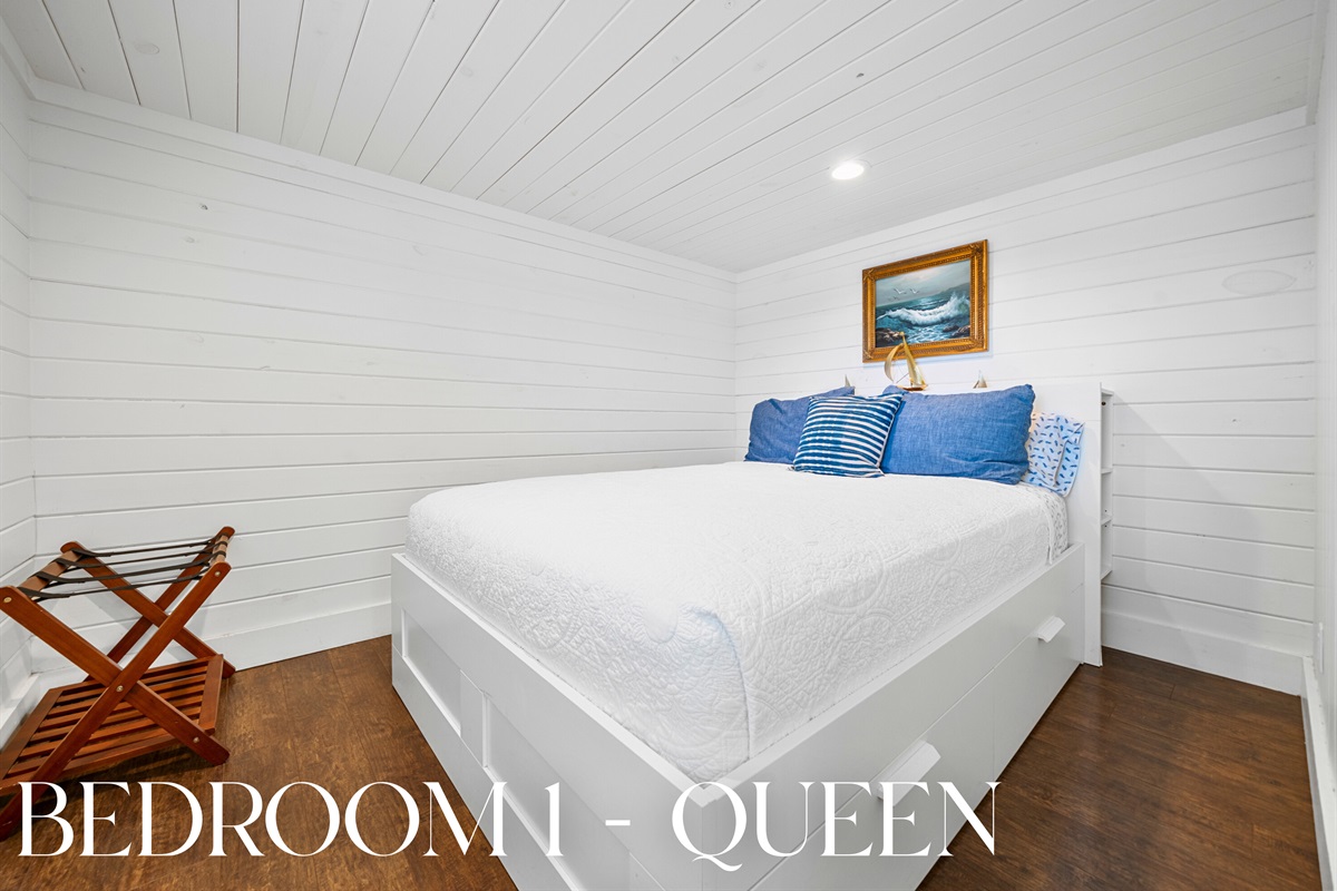 Cozy queen bedroom with a classic cottage feel, perfect for restful nights.