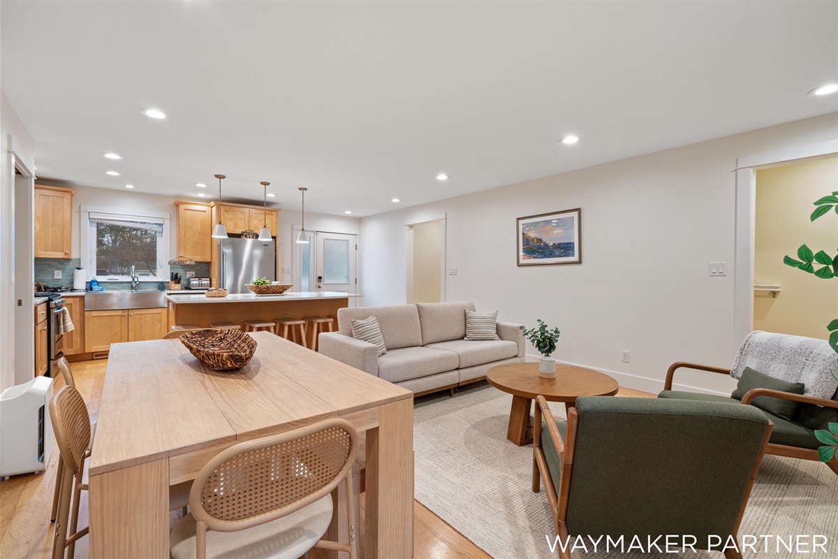Comfortable couch and chairs and a gorgeous wood dining table.