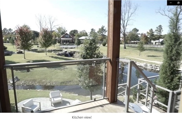 Kitchen Balcony with stairs to lower level, parking. View of the neighborhood common area.