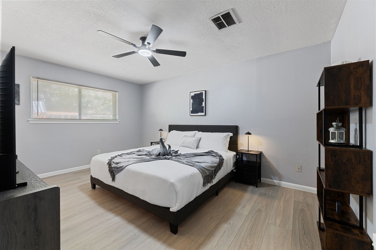 Retreat to the luxurious master suite with a king bed, private bath, and TV for ultimate comfort and privacy.