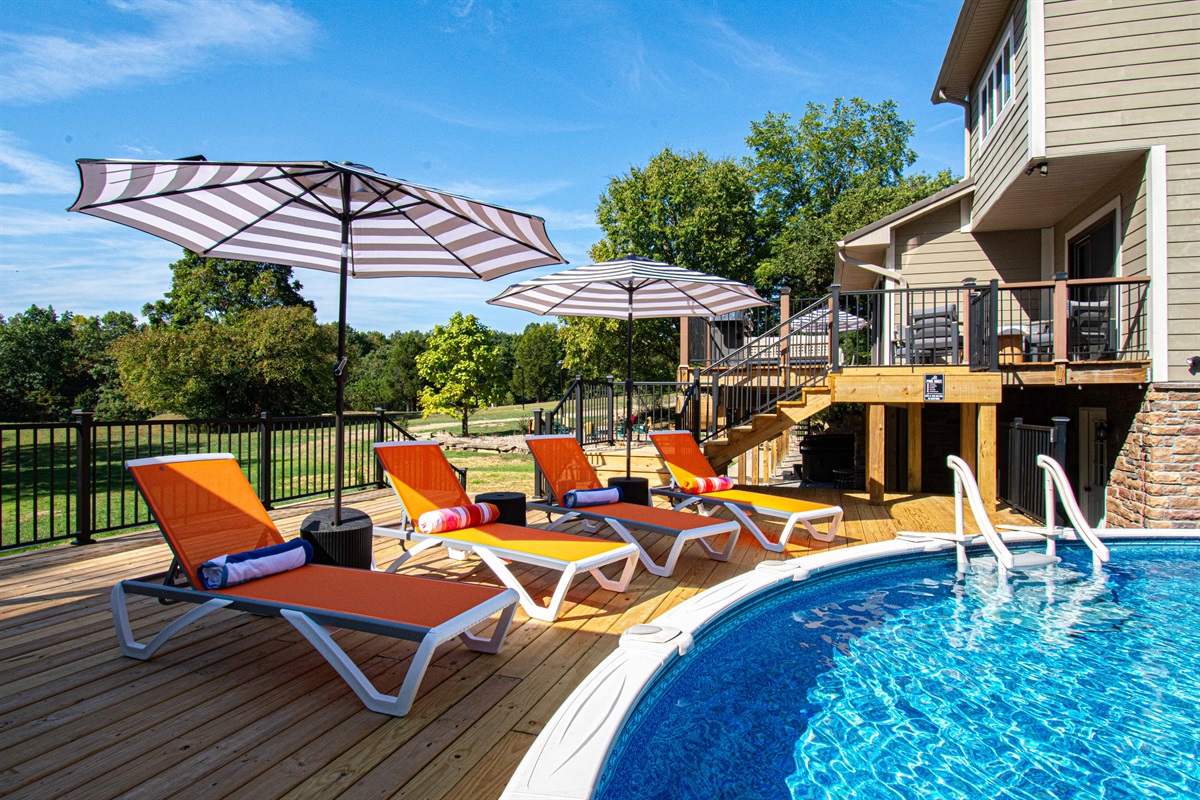 Massive pool deck with lighted pergola and loungers. Pool is not heated but open this fall due to warm weather.