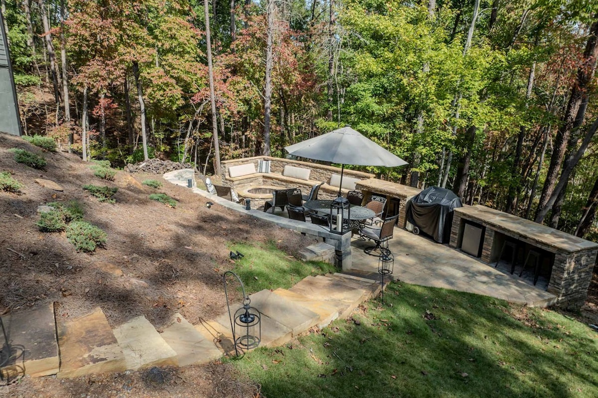 Stone steps leading from Screened Porch to Backyard area with Fire Pit