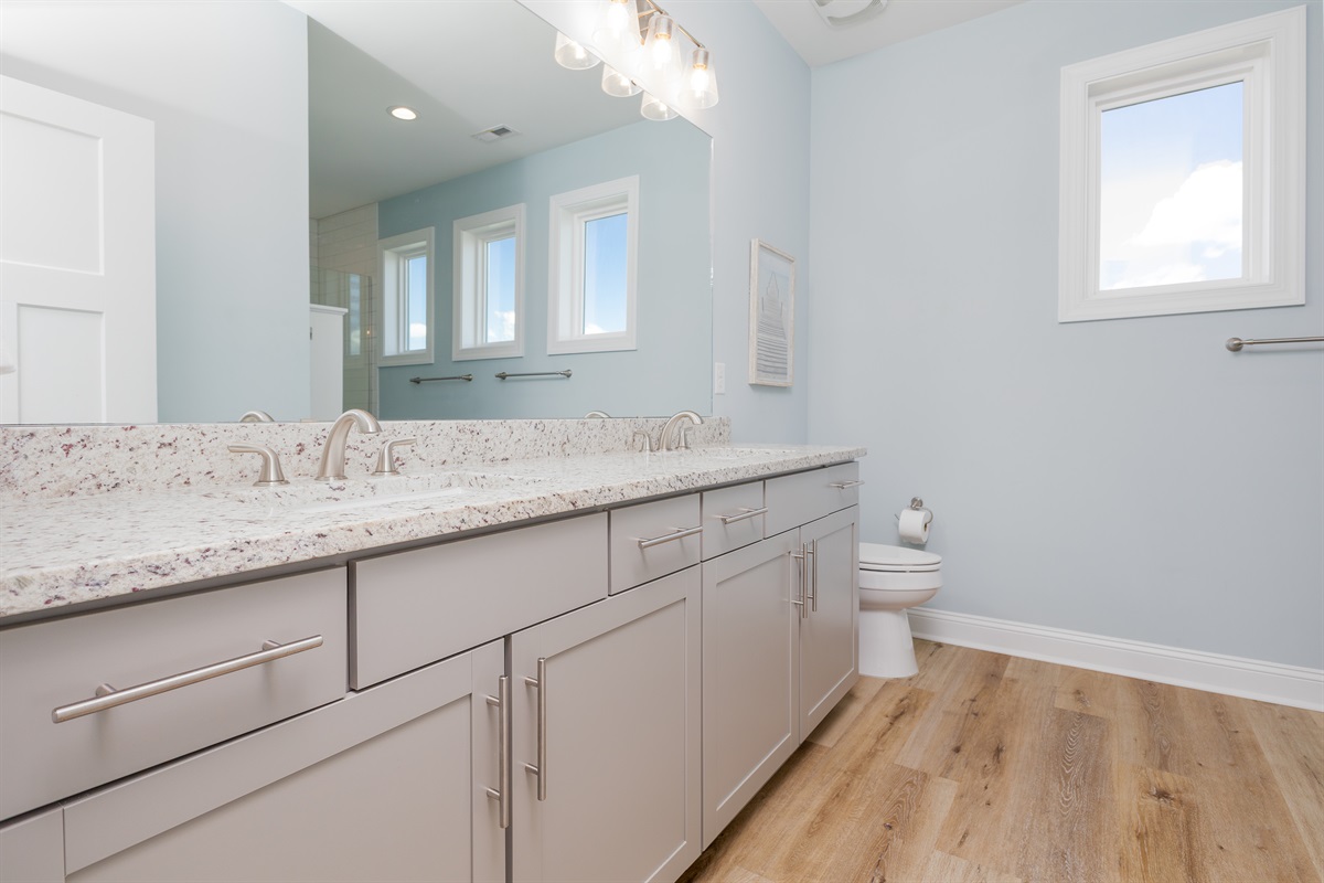 Master bathroom features a double vanity with granite countertops
