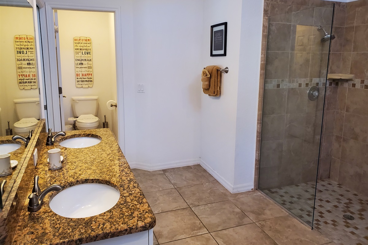 Master Queen private bathroom with walk in shower, 2 sinks and toilet