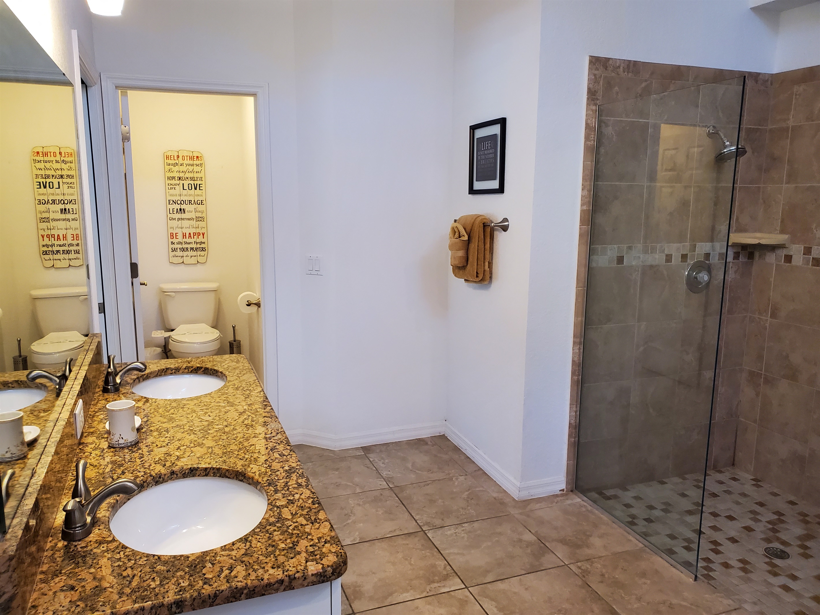 Master Queen private bathroom with walk in shower, 2 sinks and toilet