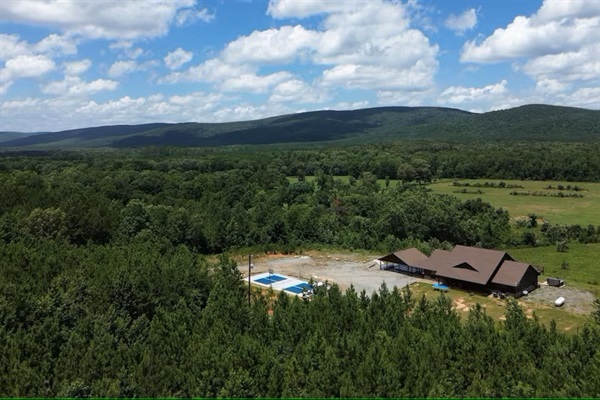 Daytime aerial showing full property layout and recreation amenities.