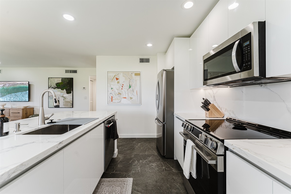 Fully equipped kitchen with everything needed for home-cooked meals. Modern appliances and ample counter space for easy meal prep. Bright and functional kitchen perfect for extended stays.