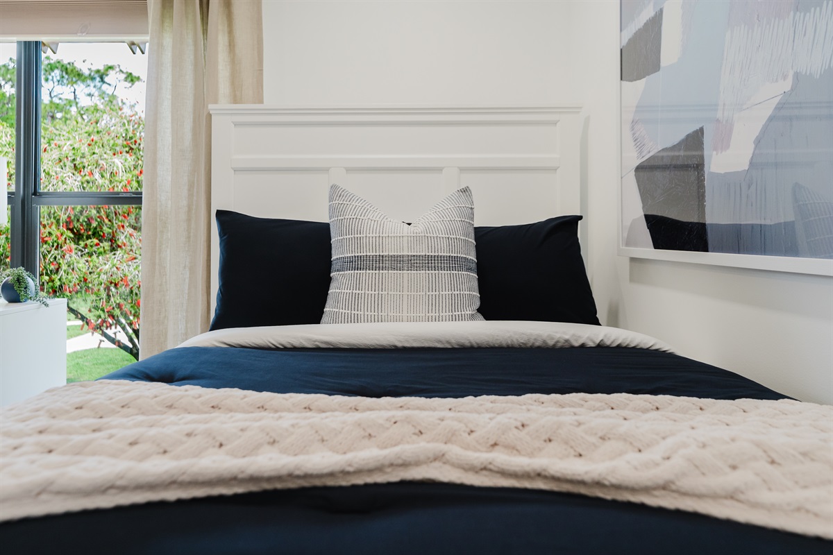 Cozy guest double queen bedroom with comfortable bedding and ample storage. Perfect space for family or friends to unwind and relax. Bright and inviting guest room with stylish touches.