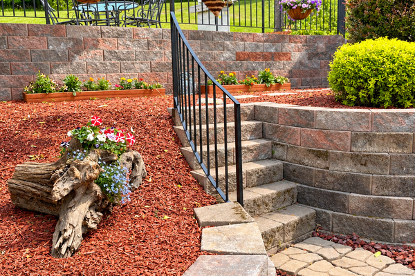 Terraced walkway from driveway to backyard with grill and pool
